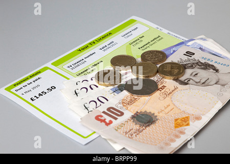 TV licence with cash to pay for it Stock Photo