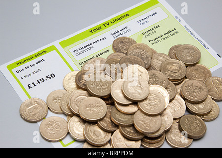 TV licence with cash to pay for it Stock Photo