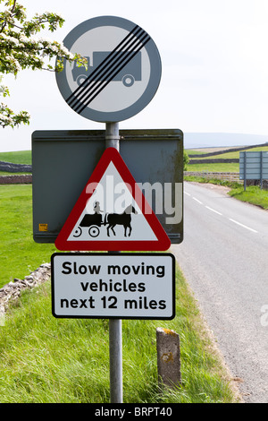 Sign on the A683 NE of Sedbergh, Cumbria warning of slow moving horse drawn vehicles travelling to the Appleby Horse Fair Stock Photo