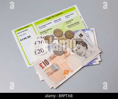 TV licence with cash to pay for it Stock Photo