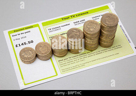 TV licence with cash to pay for it Stock Photo