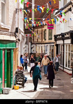 Whitby, Yorkshire, UK - Shoppers and tourists in the pretty old streets of the North Yorkshire town of Whitby, UK Stock Photo