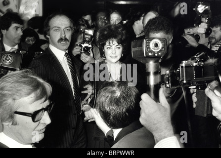 Elizabeth Taylor and bodyguards in a press of photographers Stock Photo