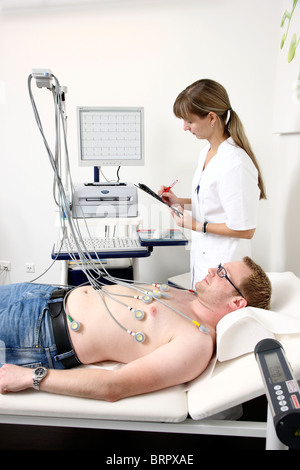 Doctor's surgery,  patient at an ECG, Electro cardiograph, test, recording,  preventive check up. Stock Photo