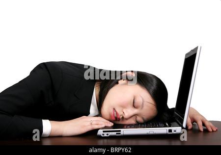 young asian woman sleeping on her computer Stock Photo
