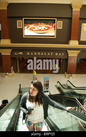 A teenage girl on the escalator, the Mandalay Bay Hotel, Las Vegas USA Stock Photo