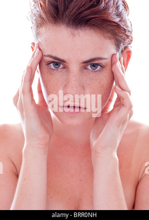 young woman with hands on temples Stock Photo