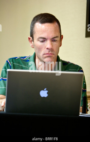 A man works on an Apple laptop, Kearney, NE, June 1, 2010. Stock Photo