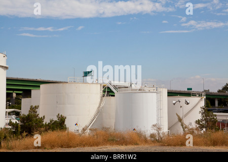 A tank farm next to a freeway in Sacramento California Stock Photo