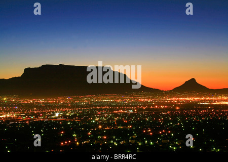 View over Cape Town city lights at sunset with Table Mountain and Lions Head in the background