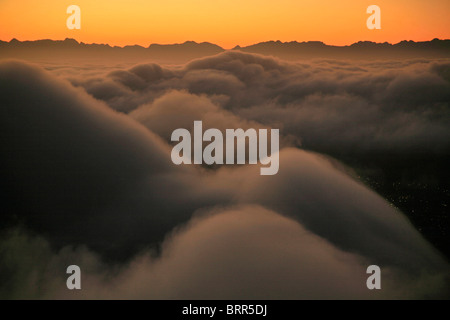 Sunrise above the swirling clouds Stock Photo