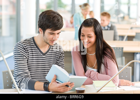 High school - two students read book in classroom Stock Photo