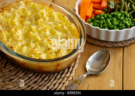 Shepherds Pie, with vegetables - carrots, french beans and peas - healthy home cooking ready to be served. Stock Photo