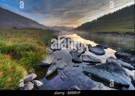 Autumn dawn on a misty Llynau Mymbyr in Snowdonia Stock Photo