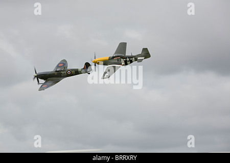 Spitfire and American P 51 Mustang fly at Goodwood Revival 2010 Stock Photo