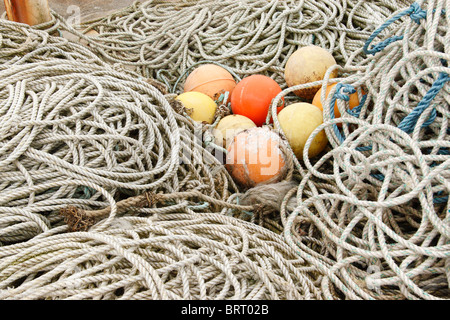 Fishing gear including ropes and buoys on quayside Stock Photo