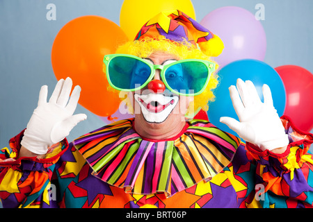 Silly clown in oversized glasses, making a surprised face.  Stock Photo