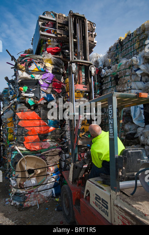Stacking one tonne bales of plastic with a forklift at a plastics recycling plant in Geelong Australia Stock Photo