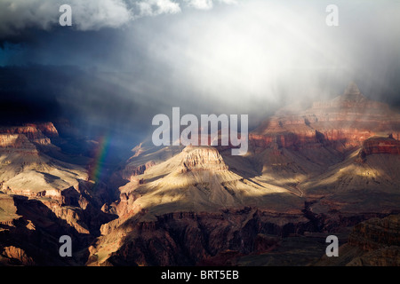 A rainbow forms over Bright Angel Canyon from Yavapai Point, Grand Canyon south rim, Arizona. Stock Photo