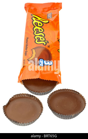 Orange packet of Hersheys Reeses chocolate covered peanut butter cups opened spilling onto a white surface Stock Photo