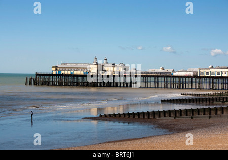Figure on beach with Hastings Pier, East Sussex, before it was destroyed in fire 5th October 2010 Stock Photo