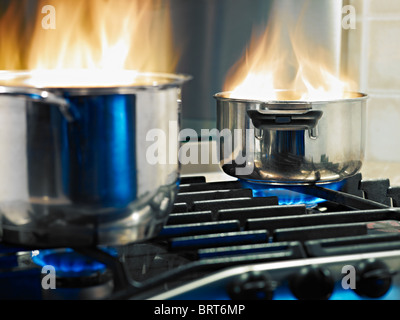 pans in fire on stoves. Horizontal shape Stock Photo