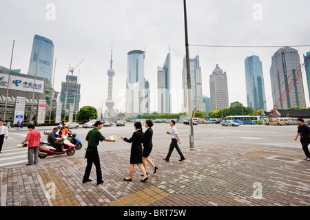 Man hands out leaflets on street to office workers break for lunch in Pudong, Shanghai China. Stock Photo