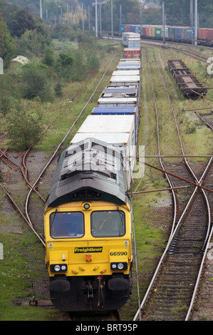 Goods train pulling out of sidings, England. Stock Photo