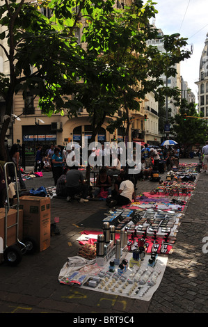 Busy street scene, with market vendors selling crafts, hats, household items on cobblestones, Peru Street, Buenos Aires Stock Photo