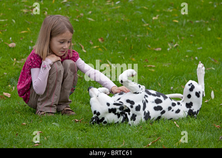 portrait of a young girl fondling her dalmatian Stock Photo
