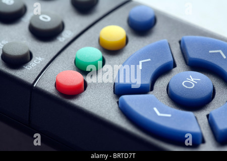 An image of a remote control for a satellite box or television with details of the controls and the red button in particular Stock Photo