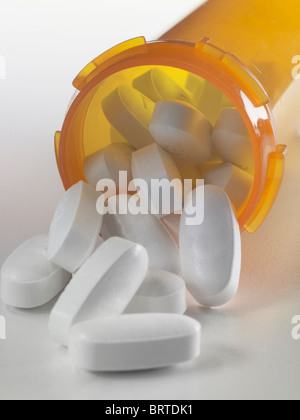 White Pills Spilling Out Of Prescription Drug Medicine Bottle, USA Stock Photo