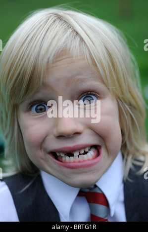 6 year old school girl pulling a silly face with a missing front tooth Stock Photo