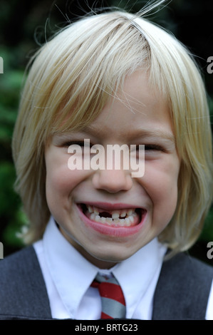 6 year old school girl pulling a silly face with a missing front tooth Stock Photo