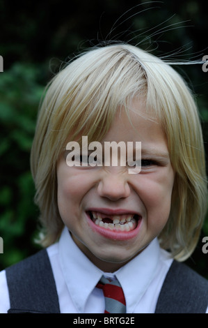 6 year old school girl pulling a silly face with a missing front tooth Stock Photo