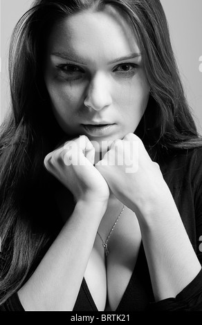 portrait of beautiful crying girl with smeared mascara Stock Photo