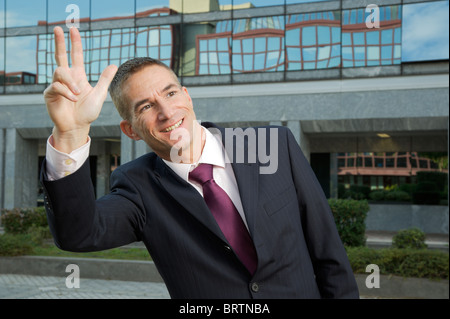 Man in a suit, smiling and calling someone, or a taxi, business concept Stock Photo