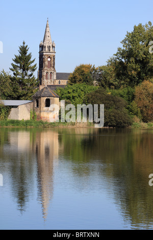 A church in the town Combourg, reflected in the waters of Lac Tranquille, Brittany, northern France Stock Photo