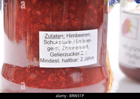 List of ingredients on a jam jar, raspberries, chocolate, raspberry brandy, lemon juice, gelling sugar Stock Photo