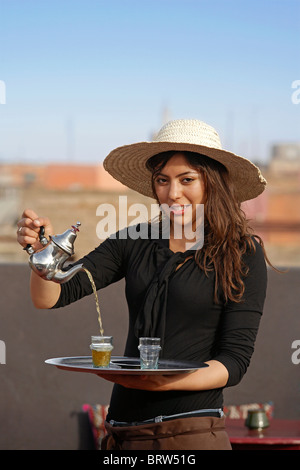 MARRAKESH: WAITRESS POURING MINT TEA Stock Photo