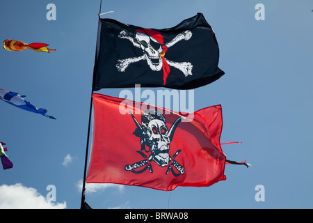 Skull and crossbones flags flying against blue sky Greenbelt Festival 2010 Cheltenham UK Stock Photo