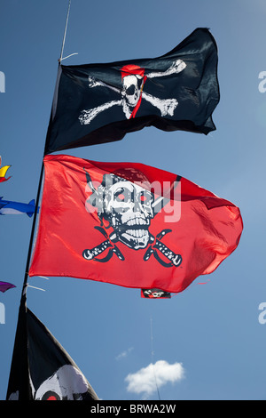 Skull and crossbones flags flying against blue sky Greenbelt Festival 2010 Cheltenham UK Stock Photo