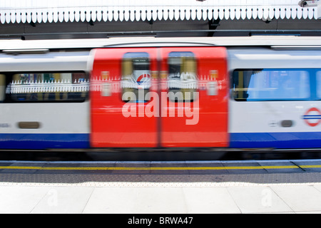Golders Green tube or underground platform , blurred train speeds through overground station Stock Photo