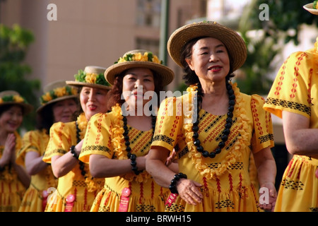 A female Japanese dance troupe from Japan performs for spectators during the Honolulu Festival parade in Honolulu, Hawaii. Stock Photo