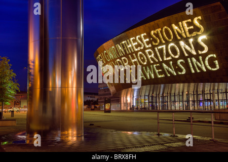 Front of Cardiff Millennium Centre arts complex and water tower fountain floodlit at night. Modern architecture in Cardiff Bay, Glamorgan, Wales, UK. Stock Photo