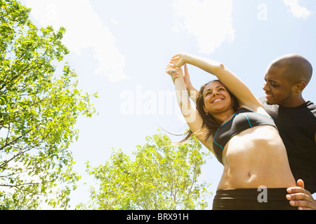 Smiling couple stretching outdoors Stock Photo