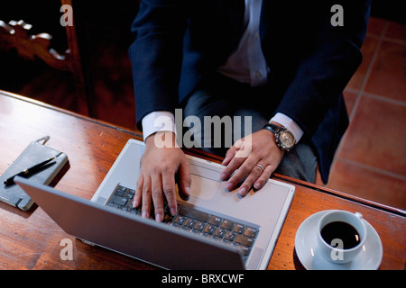 High Angle View of Man Using Laptop Stock Photo