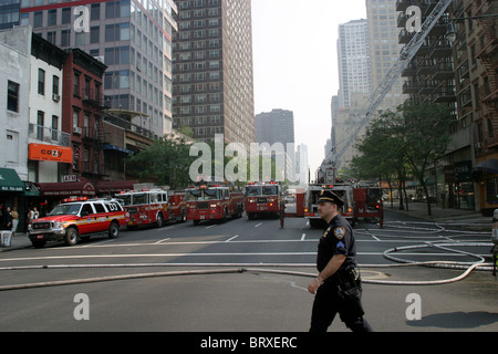 NYPD Officer at fire scene Stock Photo