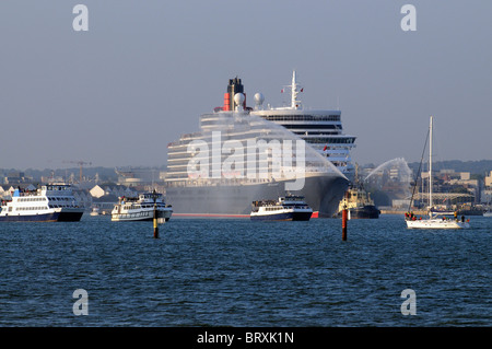Cunard's new Queen Elizabeth cruise liner departing Southampton on her maiden voyage escorted by a flotilla of small vessels Stock Photo