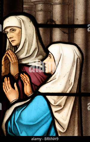 Stained glass window depicting Mary Magdalene Biblical Scene of worship and adoration Stock Photo